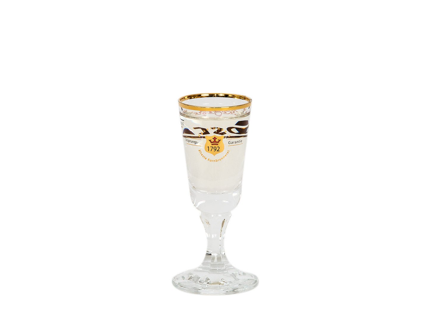 Kleines Glas mit klarer Spirituose, goldener Verzierung am Rand und Schriftzug 1792