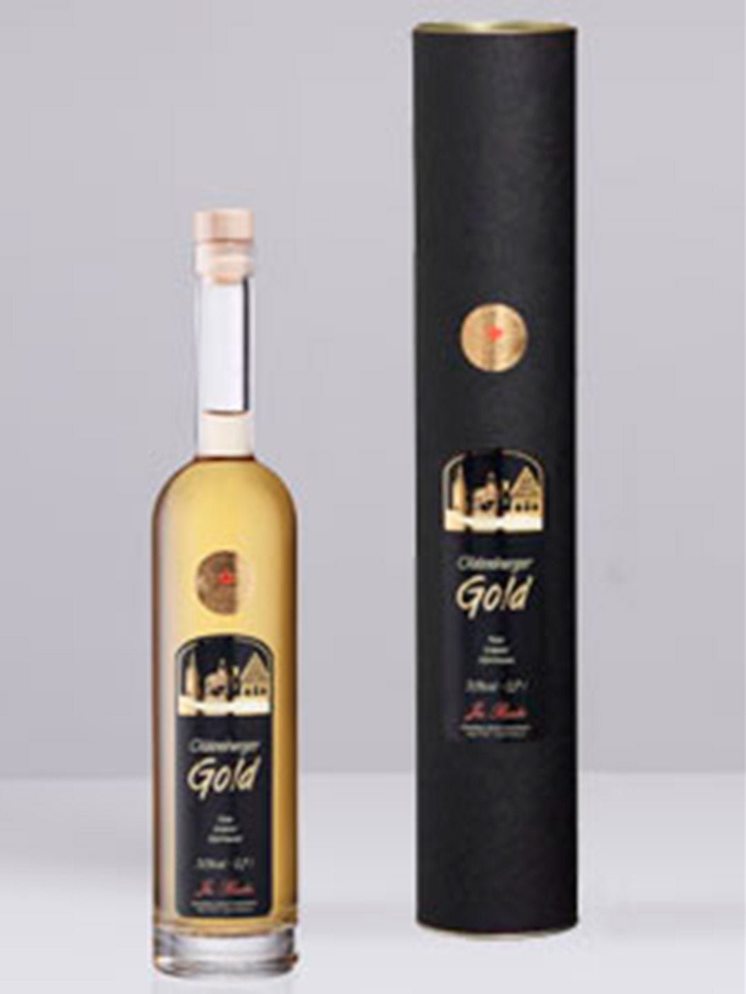 Flasche Oldenburger Gold Likör neben schwarzer Geschenkverpackung mit goldener Beschriftung