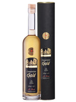 Flasche Osnabrücker Gold Kräuter-Spirituose 30% vol neben schwarzer Geschenkverpackung